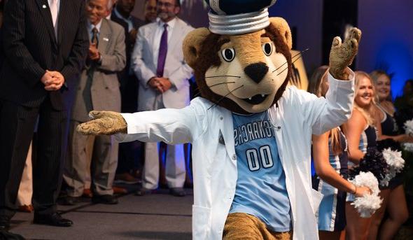 Photo of ODU's mascot dancing in front of a group of people.