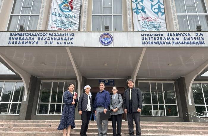 Photo of a group of people standing in front of a building.