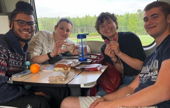 Group of four ODU students on sitting on train.