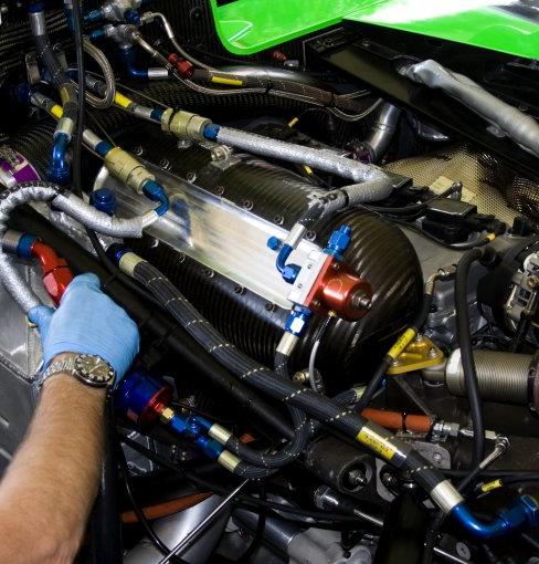 mechanic working on racing car engine